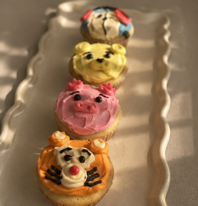 Four cupcakes decorated as cartoon animal faces